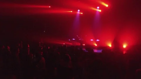 Crowd at rave party, people dance in blue light of projectors Stock Footage 70138655