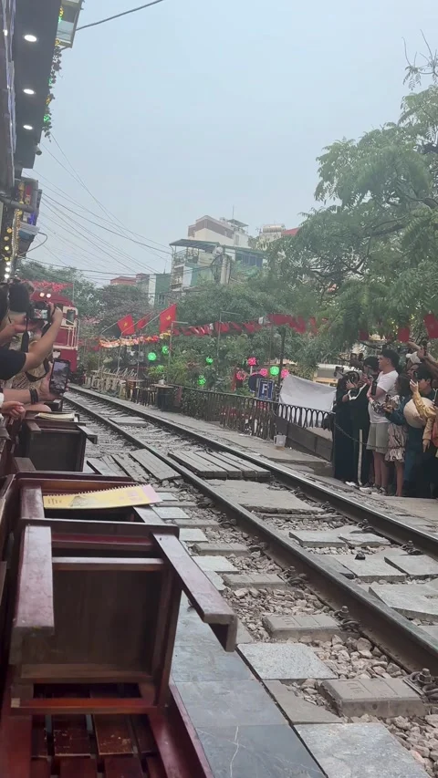 Crowd Recording Approaching Train Along Famous Train Street Railway in Hanoi Stock Footage 337956450