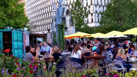 Crowd relaxing, enjoying autumn afternoon at "The Beach" in Campus Martius Park Stock Footage