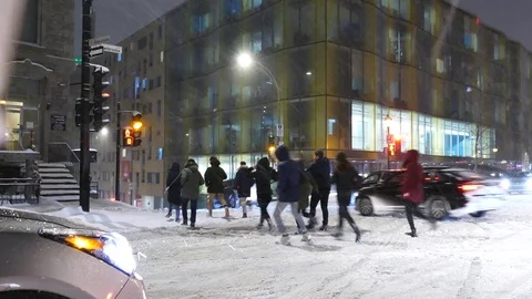 Crowd running in the street during snowfall Stock Footage 125553855