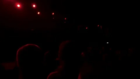 Crowd silhouettes under red stage lights Stock Footage 337800394