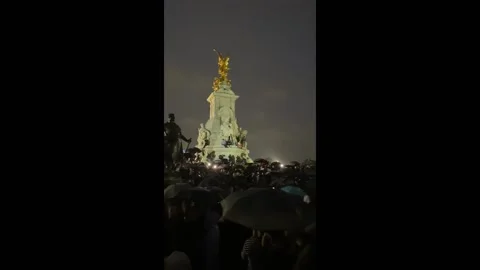 Crowd singing God Save The Queen as tribute to Her Majesty The Queens death in Stock Footage 208847546