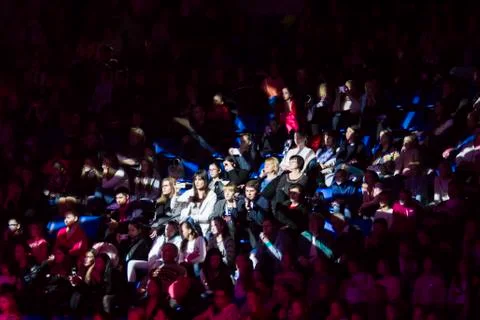 Crowd of spectators lit by a spotlight Stock Photos