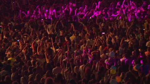Crowd of spectators on the stadium waving hands and applauding in the spotlight Stock Footage 39710615