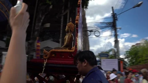 Crowd splashing water on Buddha statue during Songkran parade Thailand Stock Footage 331944877