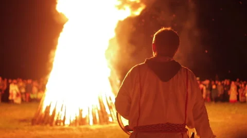Crowd standing around bonfire at night and celebrating the summer solstice Stock Footage 252566208