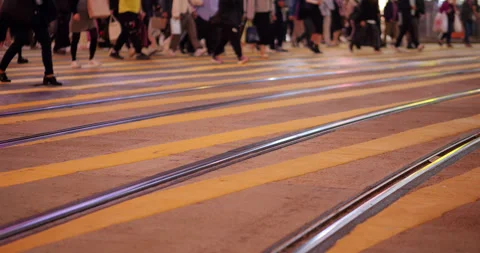 Crowd start walking at pedestrian crossing, low camera show yellow lines Stock Footage 309401345
