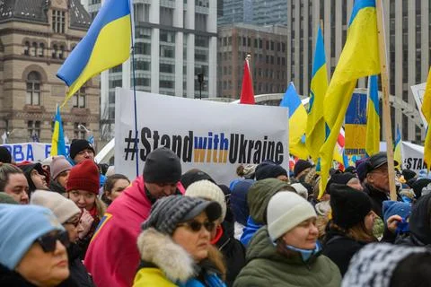 Crowd supporting Ukraine holding flags and signs at downtown Toronto rally .. Stock Photos