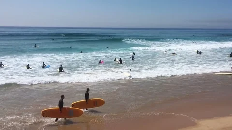 Crowd of Surfers At Beach, Panning Shot Stock Footage 80761623