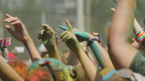 Crowd throwing hands up in air at Holi colors festival. Stock Footage 51814311