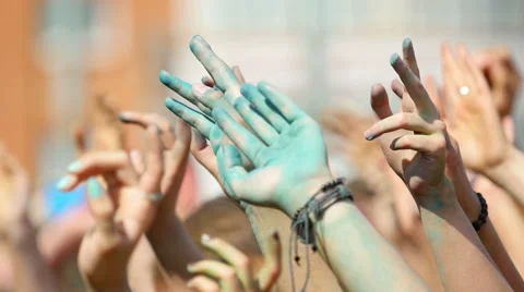 Crowd throwing hands up in air at Holi colors festival. Stock Footage 51817378