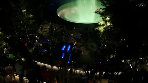 Crowd of tourists in Rain Vortex waterfall, Jewel Changi Airport Stock Footage 109117338