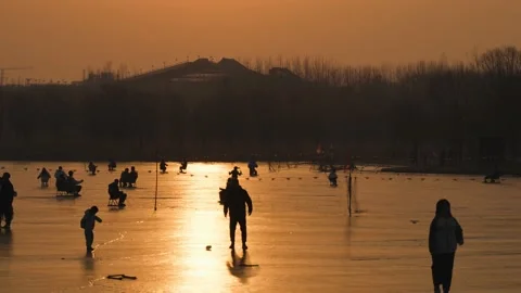 Crowd of tourists skating on ice at sunset Stock Footage 235459672