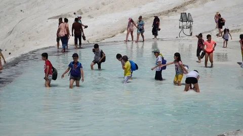 A crowd of tourists visiting the travertine pools at Pamukkale or "cotton Castle Stock Footage 89490886