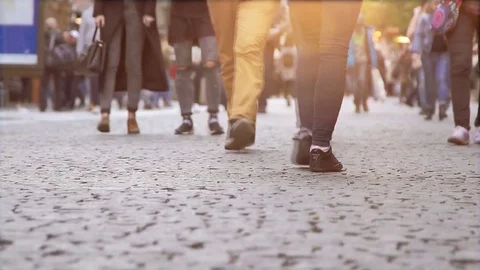 The crowd of tourists walking on a cobblestone Stock Footage 75085333