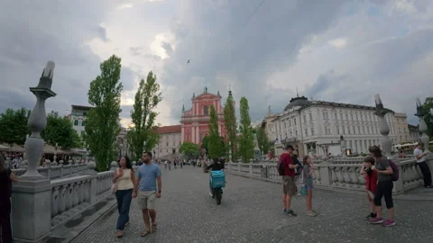 Crowd of tourists walking on the famous Triple Bridge Stock Footage 346173538