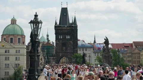 Crowd Of Tourists Walks Across Cobblestone Charles Bridge In Prague Old Town 库存影片 342279358