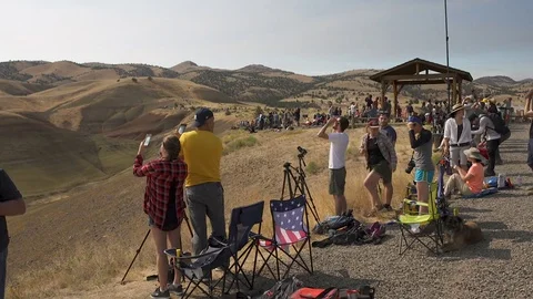 Crowd of tourists watching the Eclipse Real Time Stock Footage 79474733