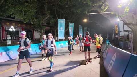Crowd of Trail Runners Gathering on Barrier Lined Start Street, Lushan Stock Footage 346701531