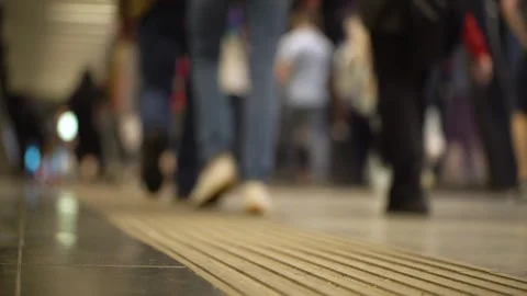 Crowd of unrecognizable pedestrians walks through the underpass city. Low angle Stock Footage 281412296