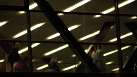 Crowd of unrecognizable pedestrians walks through the overhead crossing at night Stock Footage 282170710