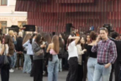 Crowd of unrecognizable people out of focus at autumn fair Stock Photos