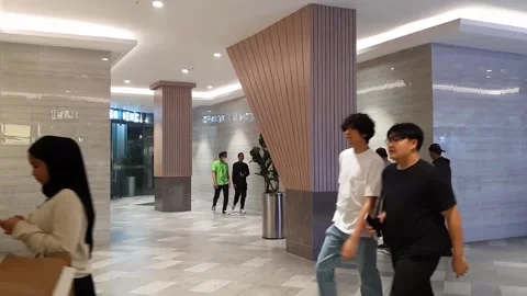 Crowd Of Visitors Inside Luxury Hotel Plaza Mall With Cream Asymmetrical Columns Stock Footage 308803799