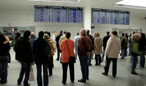 Crowd waiting at arrival gate for passengers to exit Stock Photos