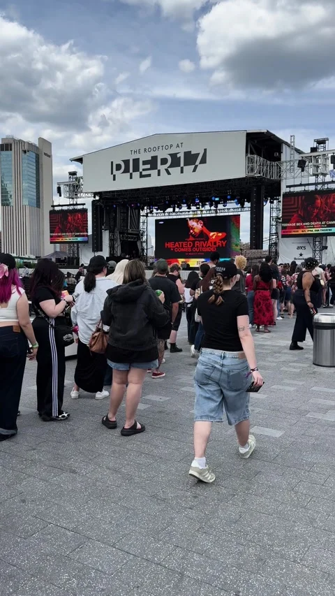 Crowd Waiting in Line at Outdoor Rooftop Stage Event on Pier 17 in New York City Stock Footage 336762157