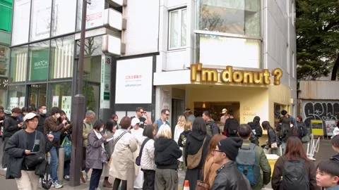 Crowd Waiting in Long Line Outside Popular Harajuku Bakery in Tokyo Stock Footage 342780862