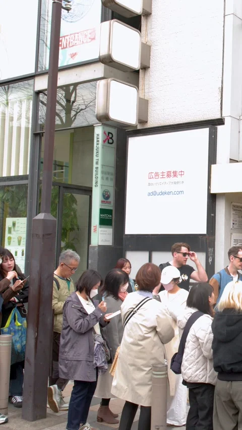 Crowd Waiting in Long Line Outside Harajuku Bakery in Tokyo Stock Footage 344518466