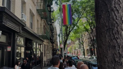 Crowd Waiting Outside Pizzeria Under Rainbow Flag on Sunny New York City Street Stock Footage 341128698