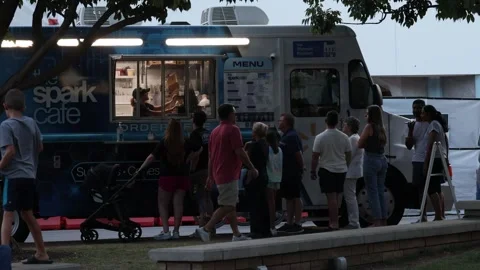 Crowd waits in line at the Walmart Spark Cafe food truck Stock Footage 345618765