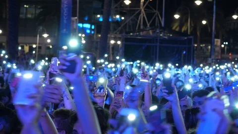 Crowd waiving hundreds of cellphone lights at a concert  Stock Footage 99698696