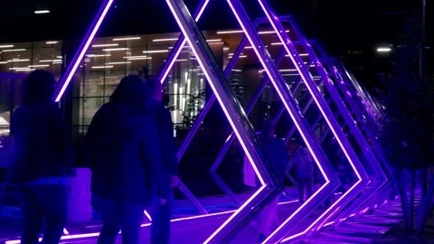 Crowd walking though tunnel of colored lights Stock Footage 219831195