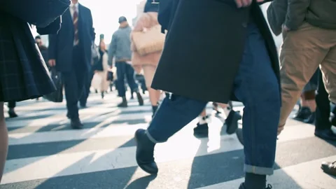 A crowd walking through a pedestrian crossing Stock Footage 161859099