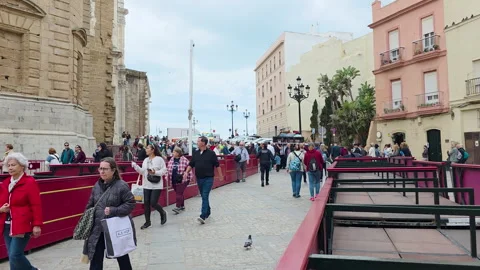 Crowd walking through Semana Santa setup near Cathedral in Cádiz Spain Video stock 332977795