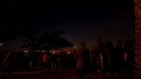 Crowd watching fireworks display Stock Footage
