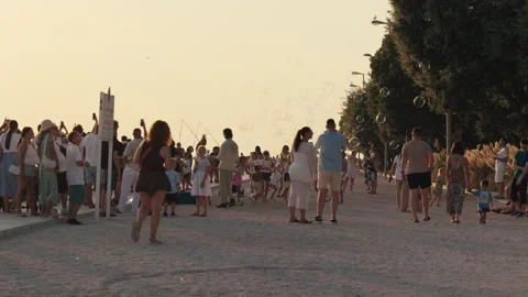 Crowd watching giant soap bubble performance on waterfront promenade in Zadar Stock Footage 340628197