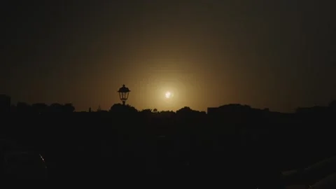 Crowd watching a glowing eclipse at dusk over a Mediterranean town (clip 5) Stock-Footage 343431267
