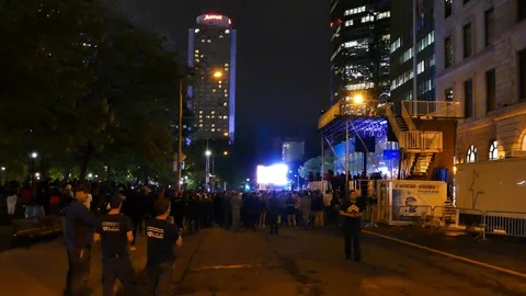 Crowd watching huge screen downtown Stock Footage 114819292