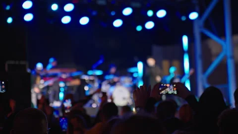 Crowd watching live concert and filming on smartphones at night Stock Footage 345452428