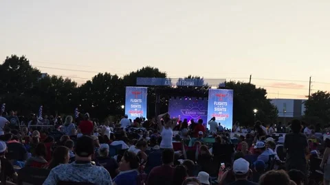 Crowd watching outdoor stage performance at dusk Stock Footage 340941185