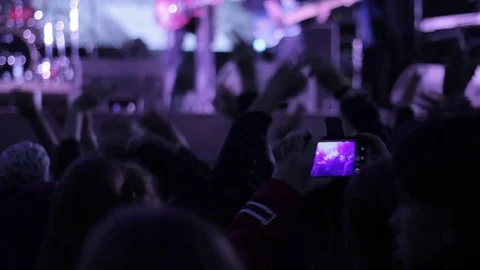 Crowd waving hands on the rock concert. Silhouettes of the people. Blury shot Stock Footage 80353454