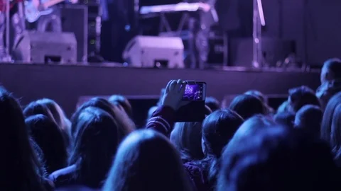 Crowd waving hands on the rock concert. Silhouettes of the people. Blury shot Stock Footage 80353743