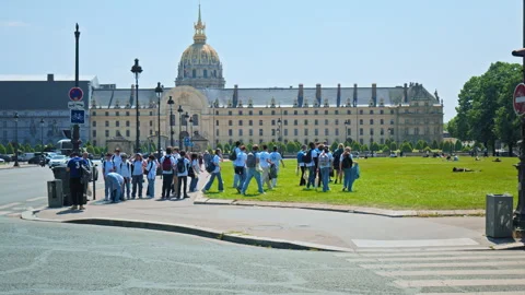 A crowd of young children coming from school explores a series of army museums. Stock Footage 245454640
