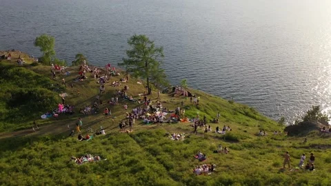 Crowd of young people dancing on a rock by the water Stock Footage 165320869