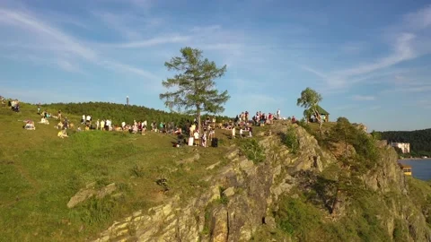 Crowd of young people dancing on a rock by the water Stock Footage 165526893