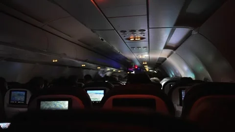 Crowded airplane cabin with passengers, typical commercial flight scene Stock Footage 279819186