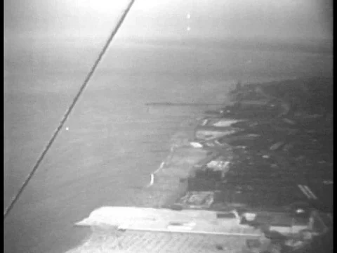 A crowded beach and a parade with a towering float is shown, in 1934. Stock Footage 79465568
